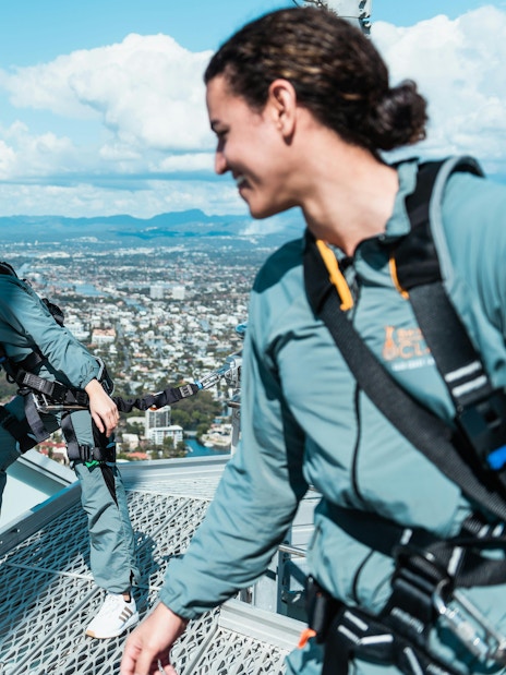 Guests climbing Skypoint in Gold Coast with ocean and city views.