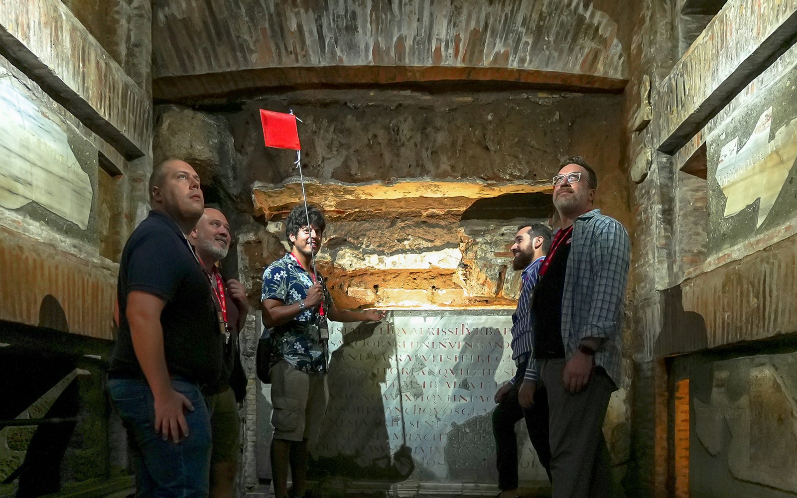 Visitors with guide exploring Capuchin Crypt in Rome, Italy.