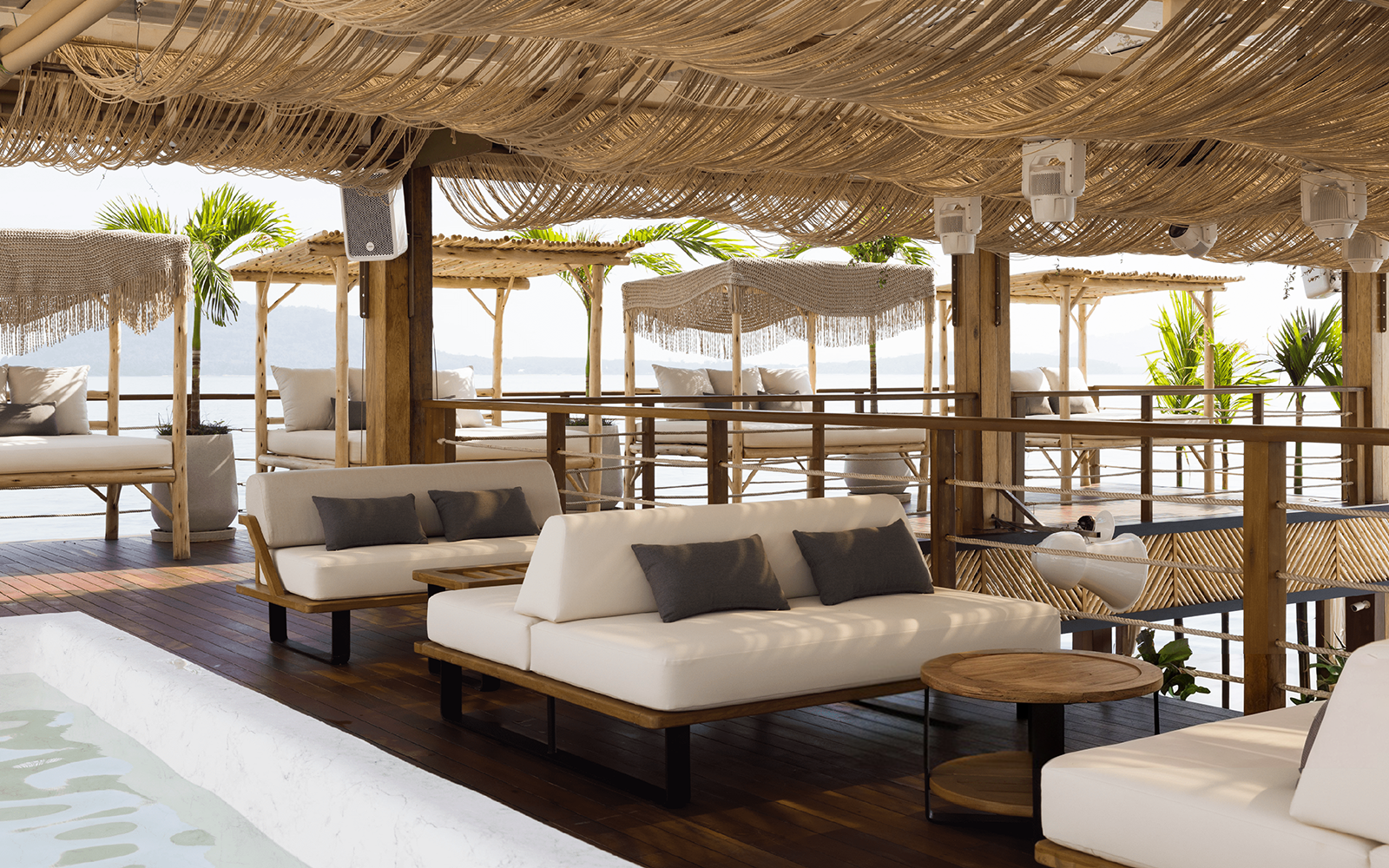 Sunset terrace at Yona Beach Club in Phuket with lounge seating and ocean view.