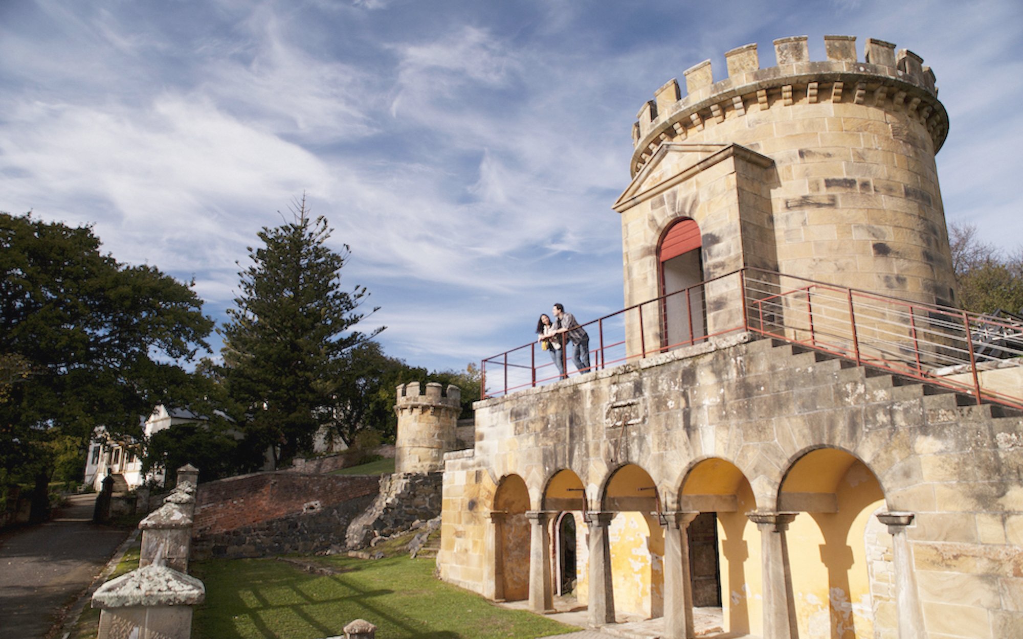 Historic building with visitors on the balcony at Port Arthur, Tasman Peninsula.
