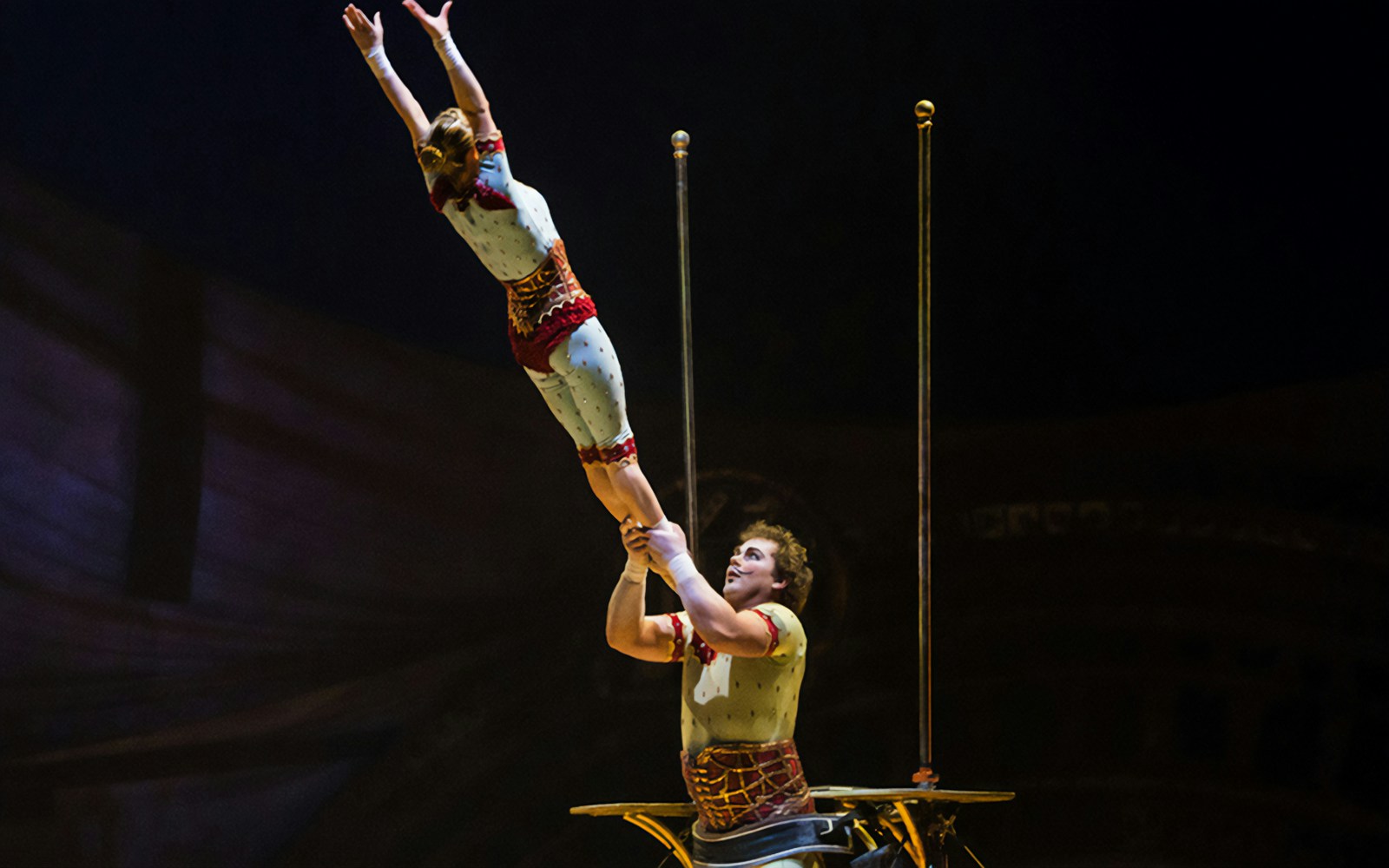 Acrobats performing a balancing act in Cirque du Soleil: Kurios show.