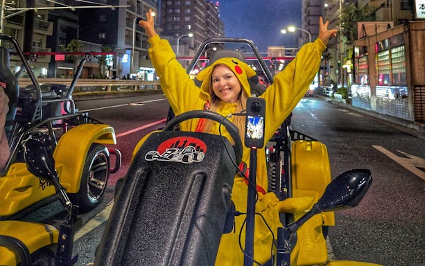 Person in costume driving a go-kart on Tokyo street during Go Kart Tokyo Old Town Tour.