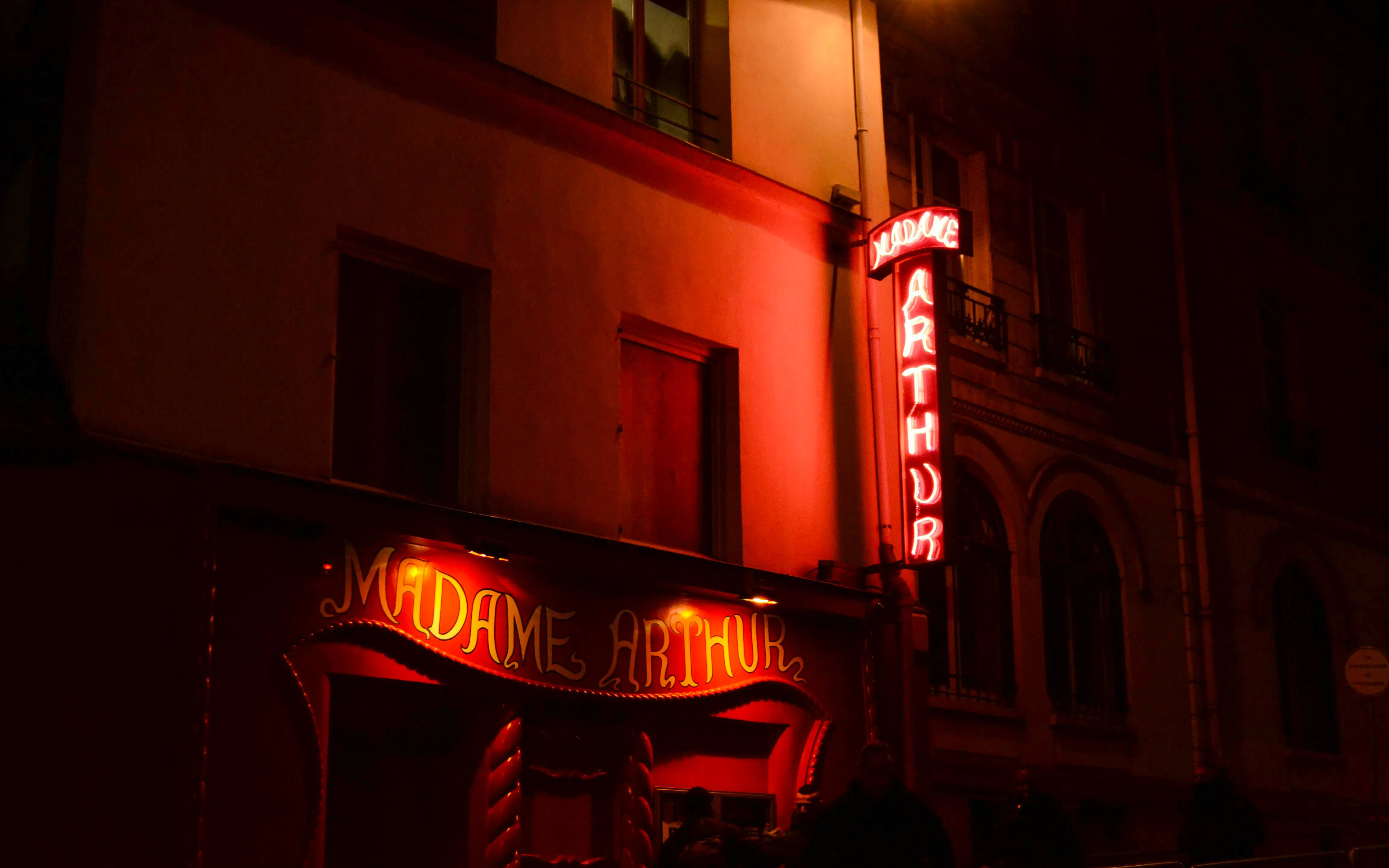 Madame Arthur cabaret entrance with neon lights in Paris.