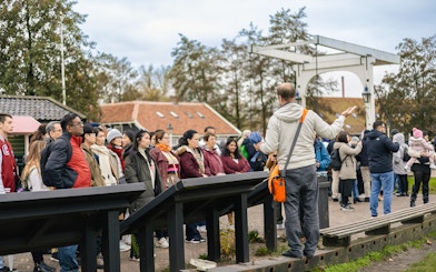 Tour guide leading a group at Keukenhof Gardens, Netherlands.