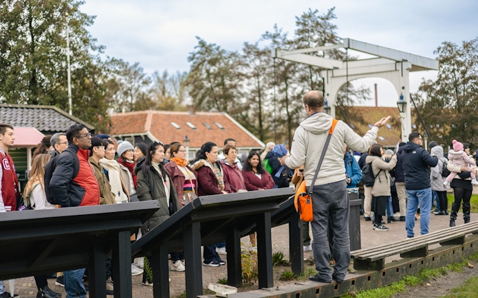 Tour guide leading a group at Keukenhof Gardens, Netherlands.