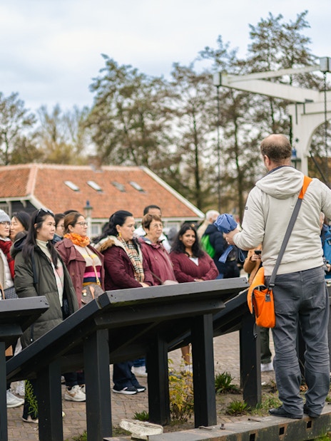 Tour guide leading a group at Keukenhof Gardens, Netherlands.
