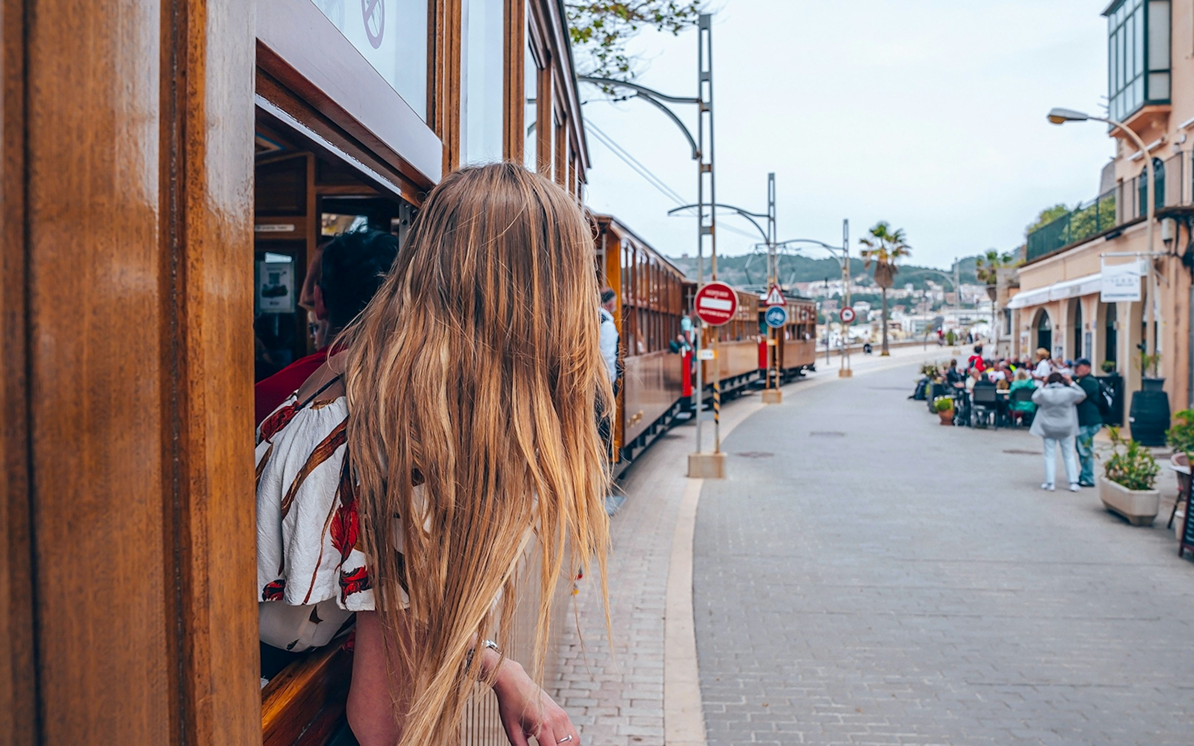 Person looking out from a wooden tram in Soller, Mallorca, during Valldemossa and Soller tour.