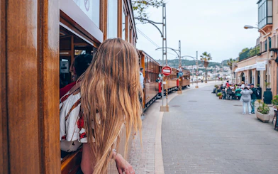 Person looking out from a wooden tram in Soller, Mallorca, during Valldemossa and Soller tour.