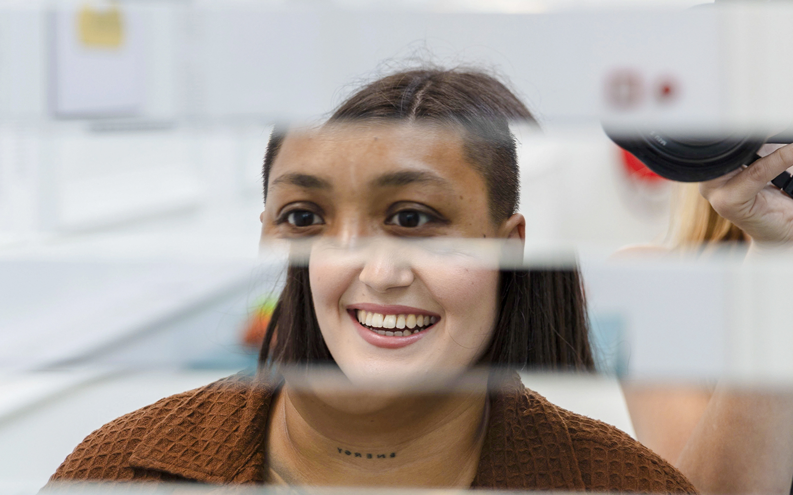Guest interacting with mirror illusion at Museum of Illusions Amsterdam.