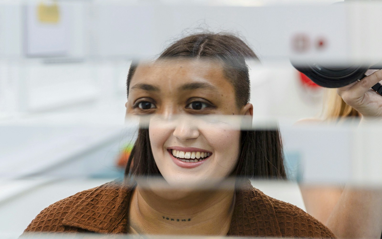 Guest interacting with mirror illusion at Museum of Illusions Amsterdam.
