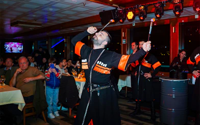 Performer with fire act on Bosphorus dinner cruise with live audience.