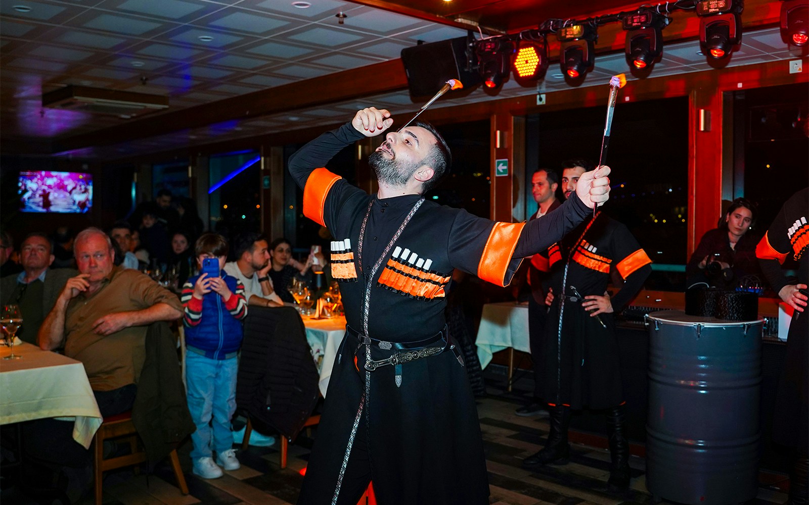 Bosphorus dinner cruise with live entertainment, Istanbul skyline in the background.