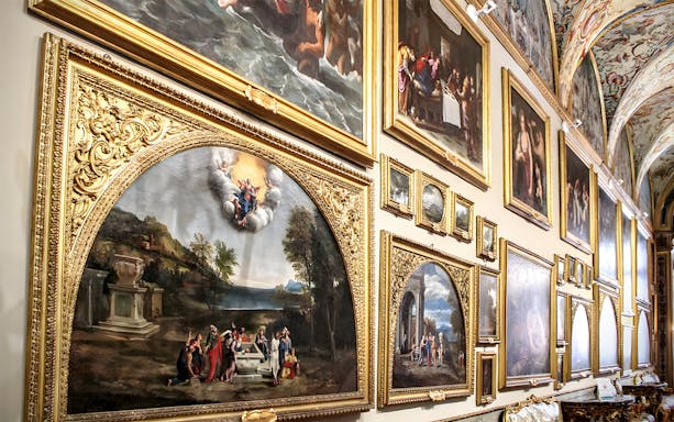Doria Pamphilj Gallery collection room with ornate paintings and sculptures in Rome, Italy.