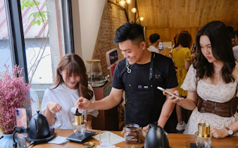 Participants learning to brew coffee at a workshop in Hồ Chí Minh City.