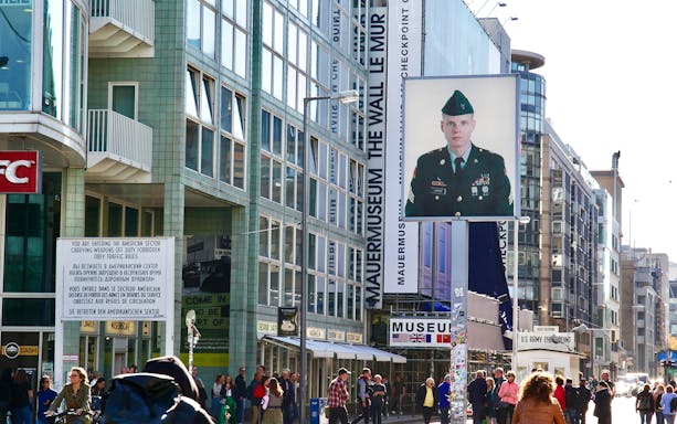 Checkpoint Charlie in Berlin with museum and soldier portrait, part of 3-hour private guided tour.