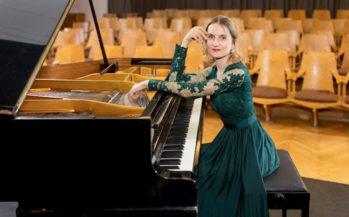 Pianist at grand piano before Chopin Concert in Warsaw Old Town.
