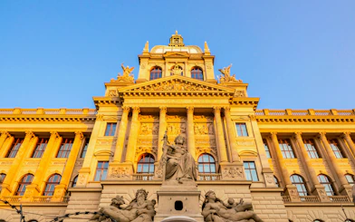 Czech National Museum facade with statues and columns in Prague, Czech Republic.