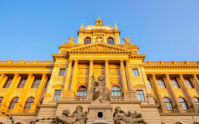 Czech National Museum facade with statues and columns in Prague, Czech Republic.