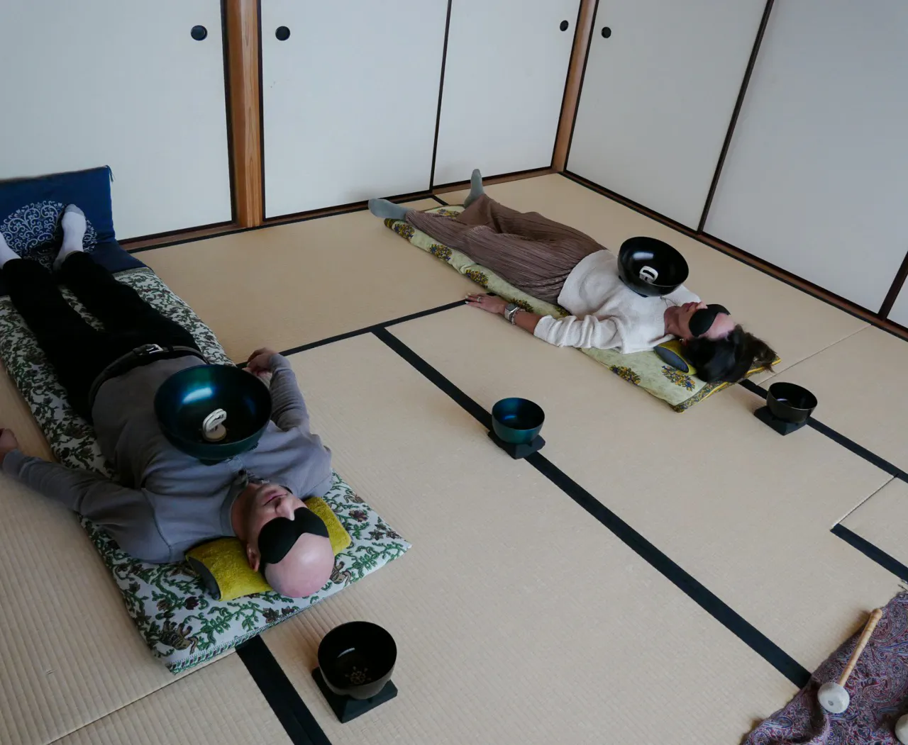 Participants experiencing a Japanese sound bath with singing bowls in Kyoto.