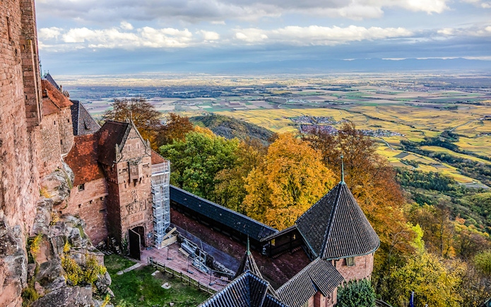 Aerial view from Haut-Koenigsbourg Castle overlooking Alsace countryside and autumn foliage.