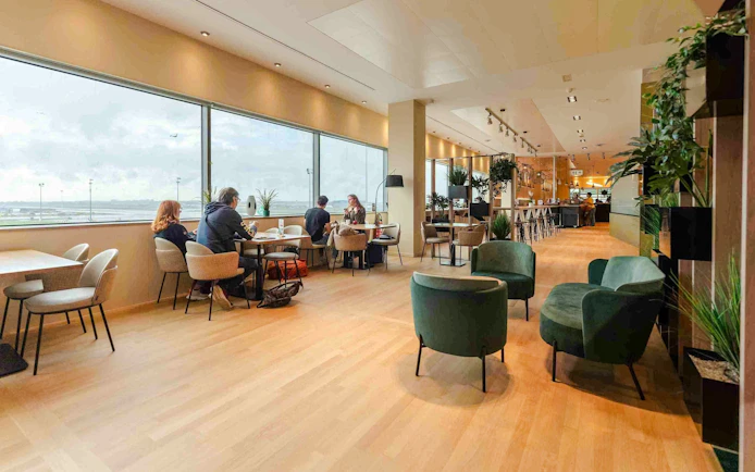 Brussels Airport Lounge interior with seating and large windows.