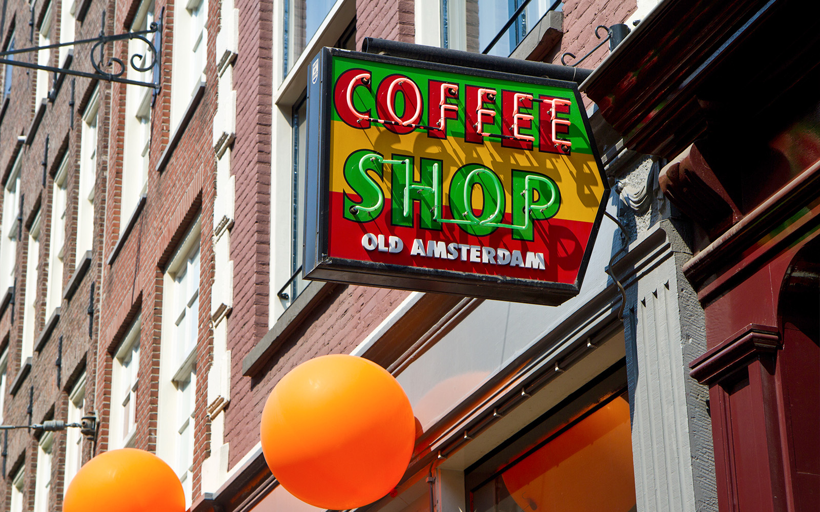Coffee shop sign with "Old Amsterdam" text in Amsterdam.