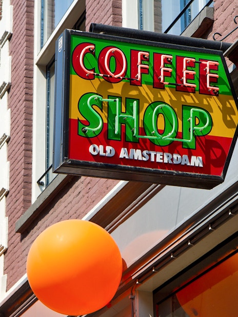 Coffee shop sign with "Old Amsterdam" text in Amsterdam.