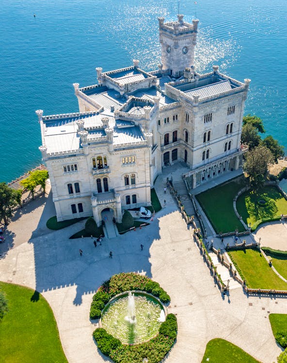 Miramare Castle overlooking the Gulf of Trieste, Italy, with surrounding gardens.