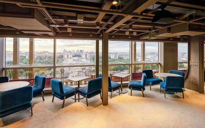 Lunch setting at Madame Brasserie, Eiffel Tower, with Paris cityscape view.