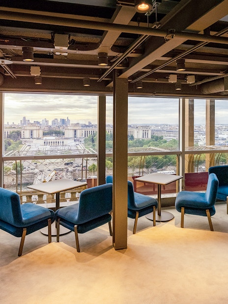 Lunch setting at Madame Brasserie, Eiffel Tower, with Paris cityscape view.