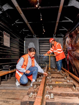 Workers inspecting railway tracks at the Swiss Museum of Transport.