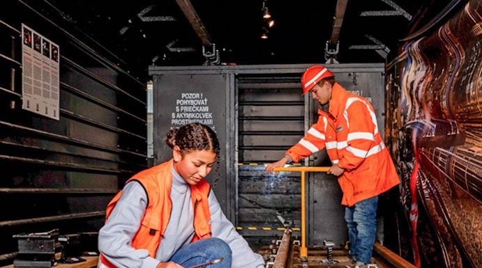 Workers inspecting railway tracks at the Swiss Museum of Transport.