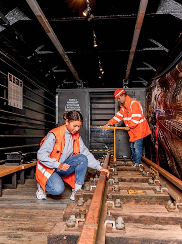 Workers inspecting railway tracks at the Swiss Museum of Transport.