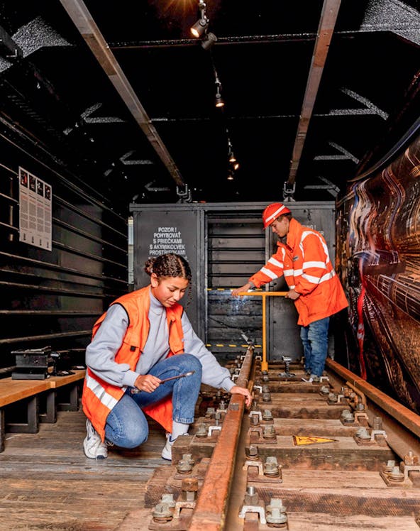 Workers inspecting railway tracks at the Swiss Museum of Transport.