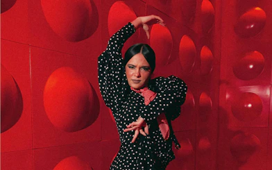 Flamenco dancer performing at Las Setas, Seville, in a polka dot dress.
