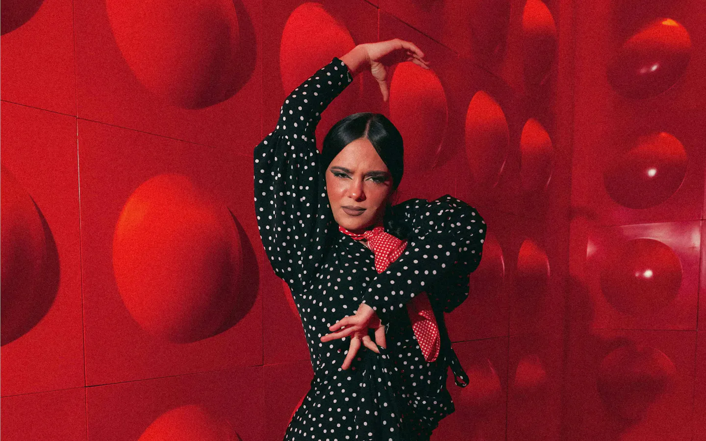 Flamenco dancer performing at Las Setas, Seville, in a polka dot dress.