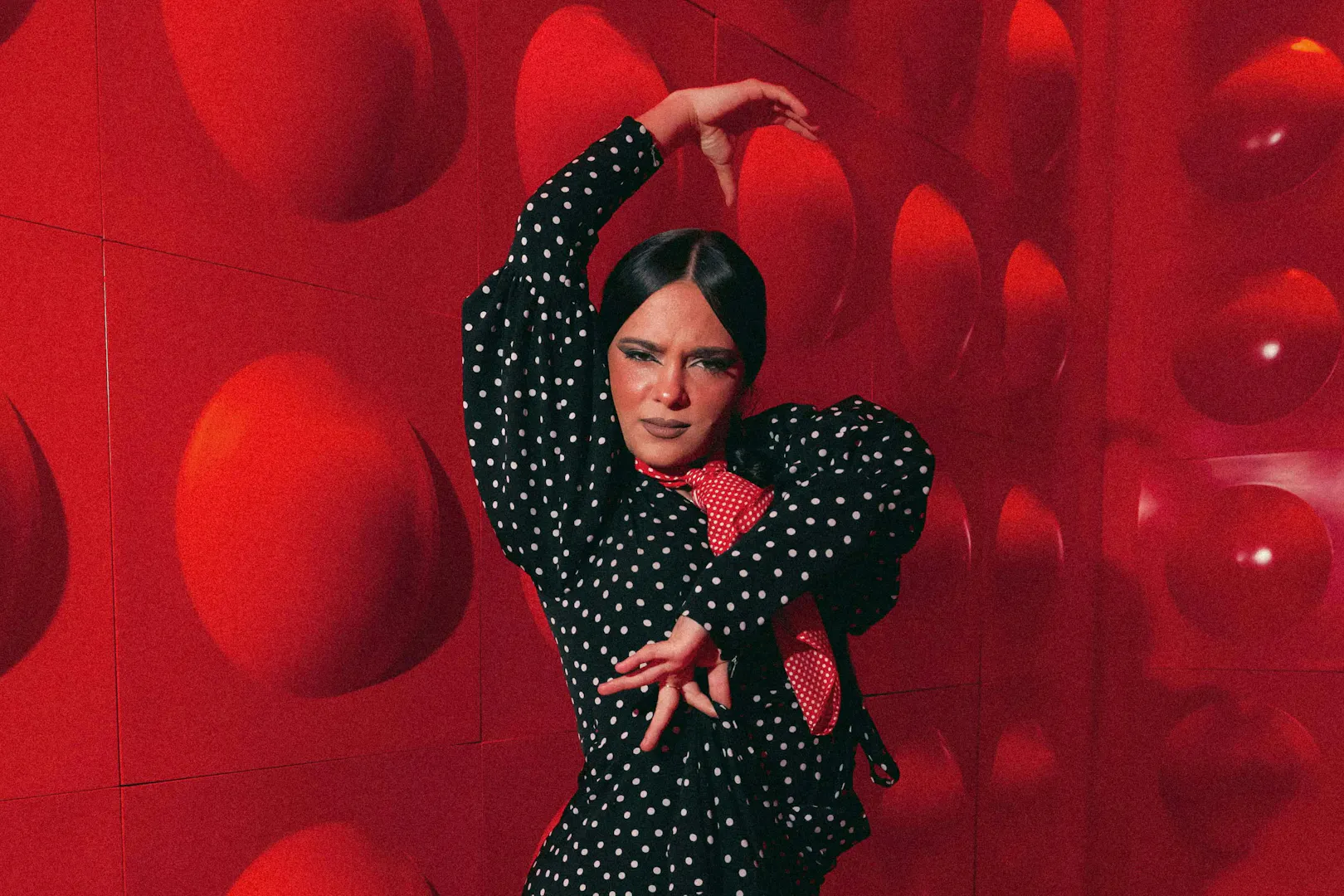 Flamenco dancer performing at Las Setas, Seville, in a polka dot dress.