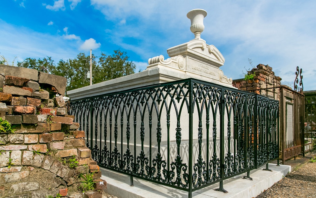 Tomb with ornate iron fence in St. Louis Cemetery, New Orleans.