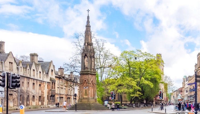 Martyrs' Memorial with historic buildings and street scene in Oxford, UK.