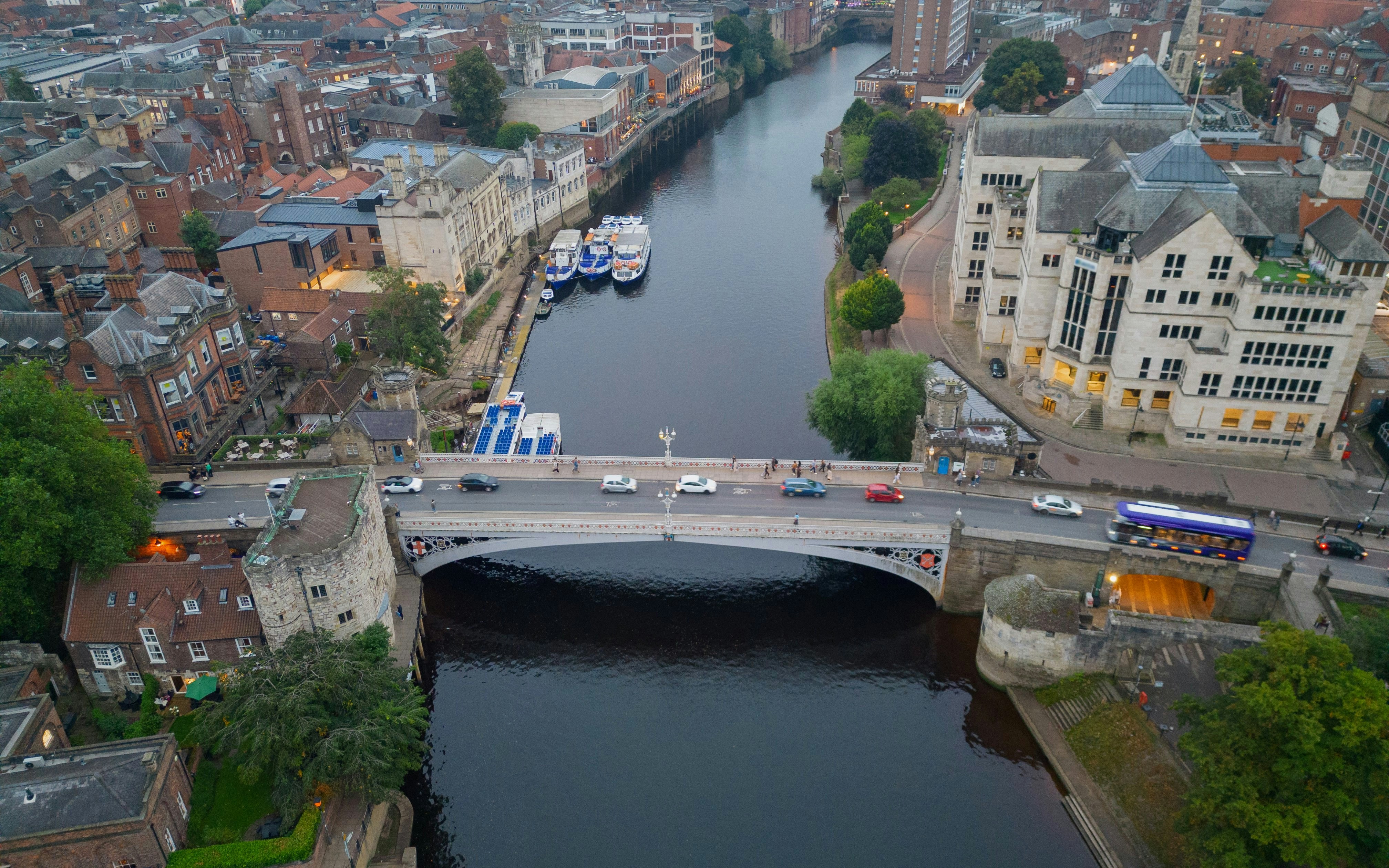 Aerial view of Lendal Bridge spanning the River Ouse in York, with surrounding historic buildings.