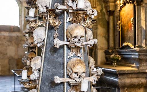 Candlestick made of human bones and skulls in Kostnice Sedlec chapel, Kutna Hora.