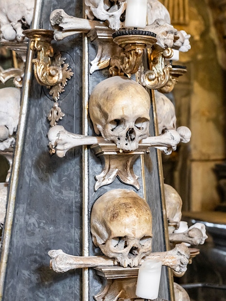 Candlestick made of human bones and skulls in Kostnice Sedlec chapel, Kutna Hora.
