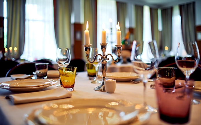 Elegant dining setup with candles at a private castle in Loire Valley.