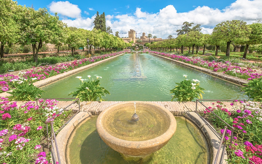 Alcazar de los Reyes Cristianos gardens with fountains and flowers, Cordoba, Spain.