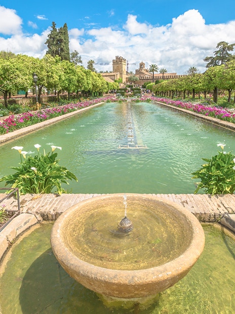 Alcazar de los Reyes Cristianos gardens with fountains and flowers, Cordoba, Spain.