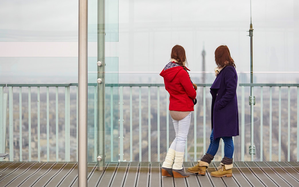 Visitors on Montparnasse Tower 56th Floor Roof Terrace, Paris.