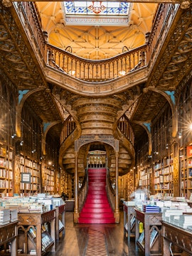 Lello Library's ornate staircase and bookshelves in Porto, Portugal.