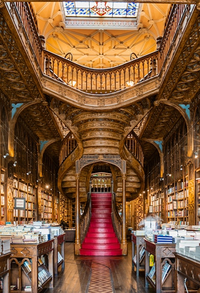 Lello Library's ornate staircase and bookshelves in Porto, Portugal.