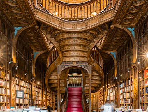 Lello Library's ornate staircase and bookshelves in Porto, Portugal.