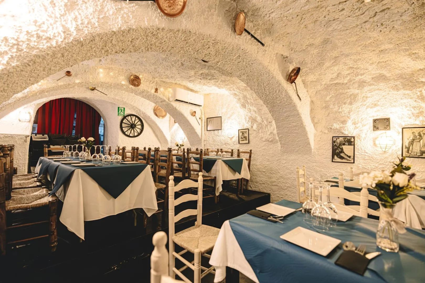 Dining area at Venta el Gallo with set tables and rustic decor, Granada Flamenco Show.